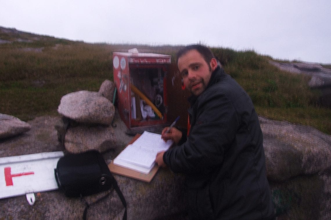 nordkapp maz signing the guest book at the top of europe