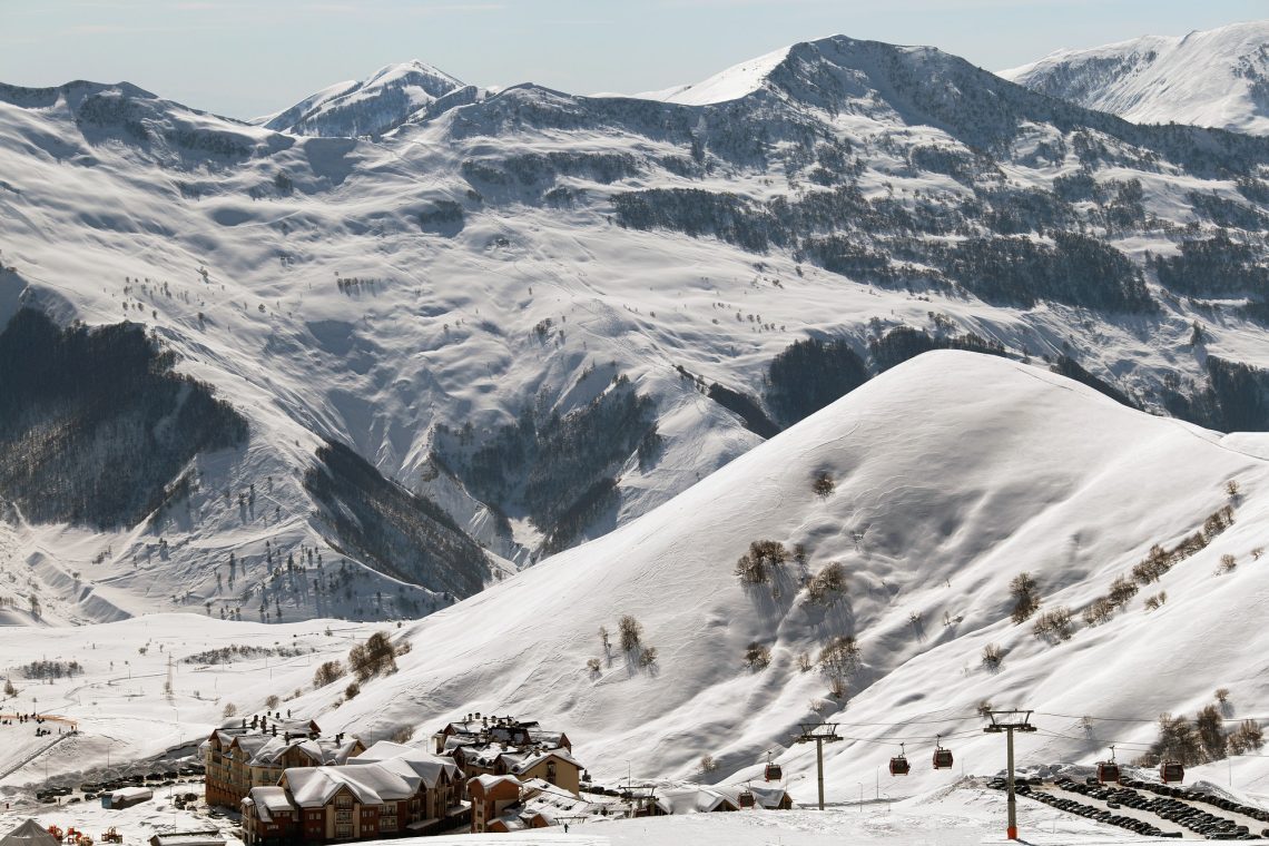 Ski lift cabins and snowy mountains. Winter ski resort
